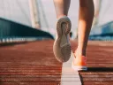 person's shoes while running on a bridge