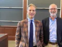 Noah Feldman and Derek Penslar pictured in a lecture room with blackboards in the background