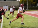Harvard player #81 runs with the ball towards the end zone with Cornell player #9 in pursuit