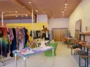 Oumille's Cambridge store interior with colorful clothing racks and display tables.