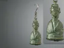 Bronze weight shaped as a bust of an empress, featuring intricate details and a hook for hanging.