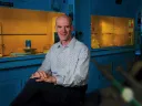 Professor David Mooney in his lab with lab hoods behind him
