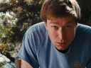 Jacob Roberts in the film Half, wearing a blue T-shirt outdoors, looking directly at the camera.