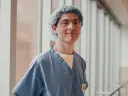 Benjamin Rapoport in surgical scrubs by a hospital window.