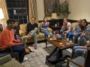 Six undergraduates and curator Joachim Homann gathered in a cozy lounge, discussing art and exhibit design.