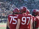 Crimson footballers on the sideline of the 2022 Harvard-Yale game