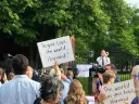 protestors outside Harvard Science center holding signs saying "Do you love the world, Harvard?" and "The world has your back, Harvard."