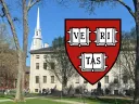 FAS shield in the foreground with University Hall in the background