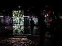 a person in a gallery with a few walls of technological art on display
