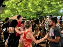 a crowd of people dancing in a street