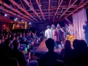 group of students perform on a stage in front of a crowd