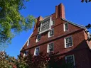 Gold clock on the top of Massachusetts Hall 