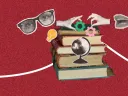 Stack of books with glasses, hands, gears, a globe, and a lightbulb on a red background.