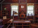 Room filled with furniture made from tightly rolled newspaper sheets.