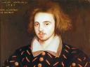 Renaissance portrait of young man thought to be Christoper Marlowe with light beard, wearing ornate black coat with gold buttons and red patterns.
