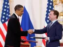 President Obama and Medvedev of Russia shake hands after signing the New START treaty in 2010