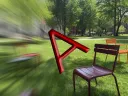 Red letter "A" overblurred lawn with colorful chairs in the background.