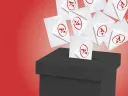 White envelopes with red symbols falling into a black ballot box against a red background.