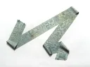 A long, patterned fabric ribbon in shades of blue and green, draped on a white background.