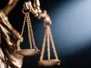 Close-up of a bronze scale symbolizing justice, with soft lighting in the background.