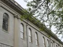 University Hall exterior with ornate windows and greenery.