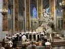 A group of choir singers performs in a cathedral