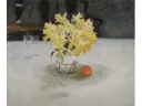 A vase of yellow flowers on a table next to an orange and a glass.