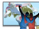Two fans celebrate in front of a TV showing a football game.