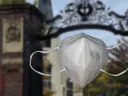 n95 mask in the foreground, Harvard Yard in the background 