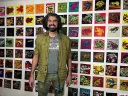 Bradley Scott Davis standing in front of a wall of frog paintings