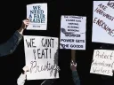 A photo montage of protest signs; one reads, "Workers are Harvard's true endowment."