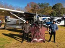 Alejandro Montagna standing in front of a small airplane wearing a wingsuit