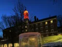 Close-up image of an "ice lantern" (a light set in an ice casing) in the snow on Radcliffe Quad
