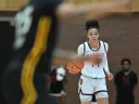 Harmoni Turner '25 brings the basketball up the court.