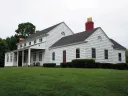 The dining hall of the Harvard crew’s training camp, with its game-room addition at right, overlooks the Thames river.