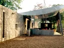 This country house, built for a filmmaker, includes a portico that becomes communal space when the owners aren't using it.