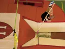 Weiler on his way up to clear the bar (green, at left). Note the bend in his pole, far below. The orange foam pads cushion landings. 