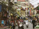 Hanoi&rsquo;s streets (in 2007, above) are now full of motorcycles and scooters, and shop shelves are no longer bare.