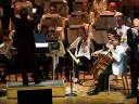 Johnson plays his harmonica with the Boston Pops orchestra behind him.