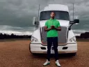 Photograph of Gary Jones standing in front of a tractor trailer truck