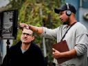 Screenwriter Julian Breece working with a colleague on set