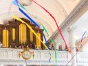 Graduating students carry streamers into Memorial Church.