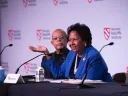 Ruth Simmons sits at a table on the stage with Henry Louis Gates, Jr. 