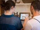 Brianna Macgregor '16 and Ozdemir Vayisoglu '16, both fellows at the Summer Humanities and Arts Research Program, digitally access information about an object at the Peabody Essex Museum (PEM) in Salem, Massachusetts, during a workshop on cultural interpretation. 