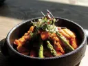 Spicy rice cake topped with fresh vegetables 