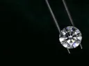 Diamond held by metal tongs