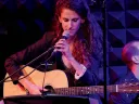 A photograph of Zoe Sarnak performing on stage