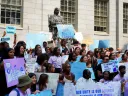 Photograph of student rally against the Supreme Court decision with the John Harvard statue in the background