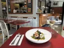 Strip T&rsquo;s nuanced fare, such as these sea scallops with yellow curry and chanterelles, is served in simple environs. 