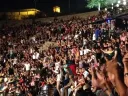 During Ramadan in Tunis, an undergraduate observes, the mood is celebratory and marked by a spirit of generosity. The photograph shows the audience dancing during a late-night traditional concert held at the Roman amphitheater in Carthage, Tunis.